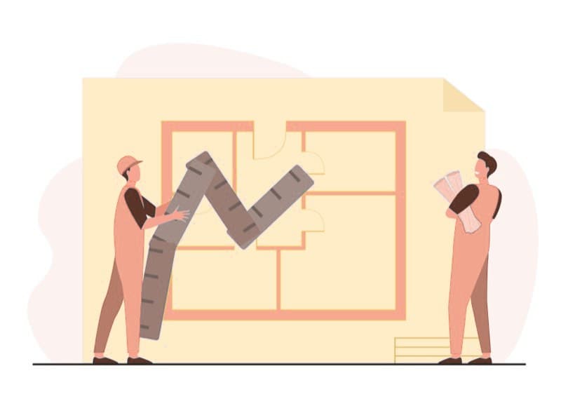 A team studying a floor plan and apartment drawings on a desk.